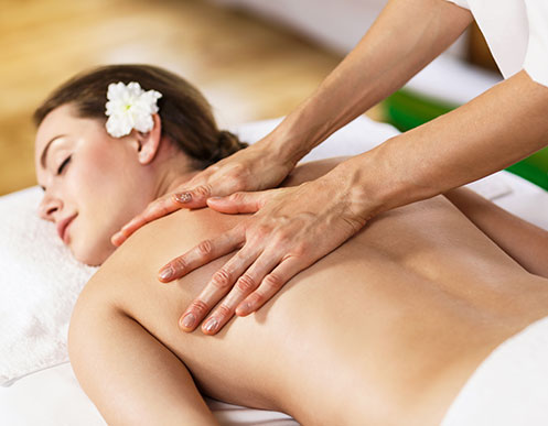 A woman receiving a massage therapy treatment in Falmouth, MA